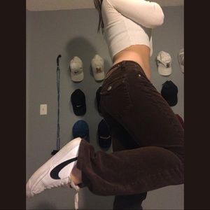 Brown low-rise corduroy bootcut jeans.